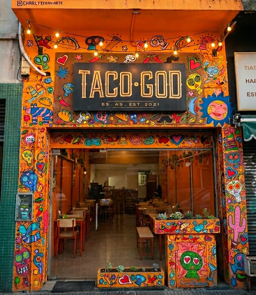 Frente de Taco God en Chacarita: fachada naranja pintada a mano con el cartel TACO GOD, Bs. As., est. 2021
